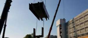 Bridge section hanging from crane