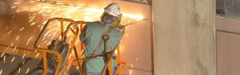 Worker cutting a wall