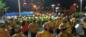 Workers gathered in the street at night