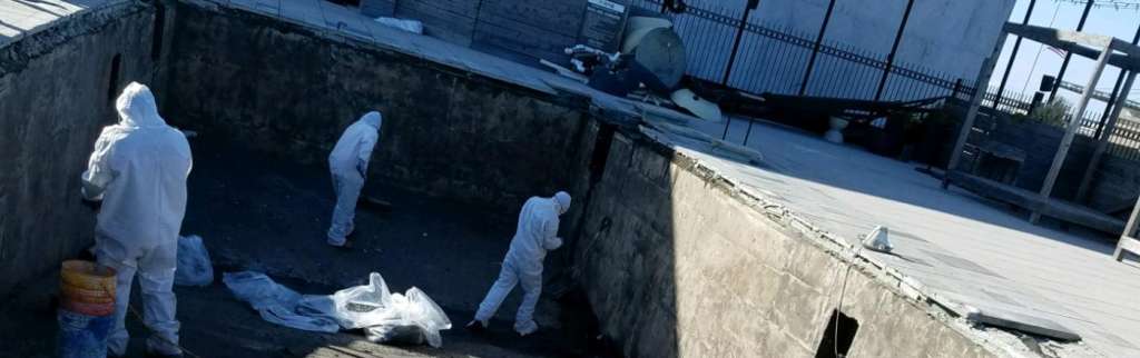 Workers prepping concrete in hazmat suits